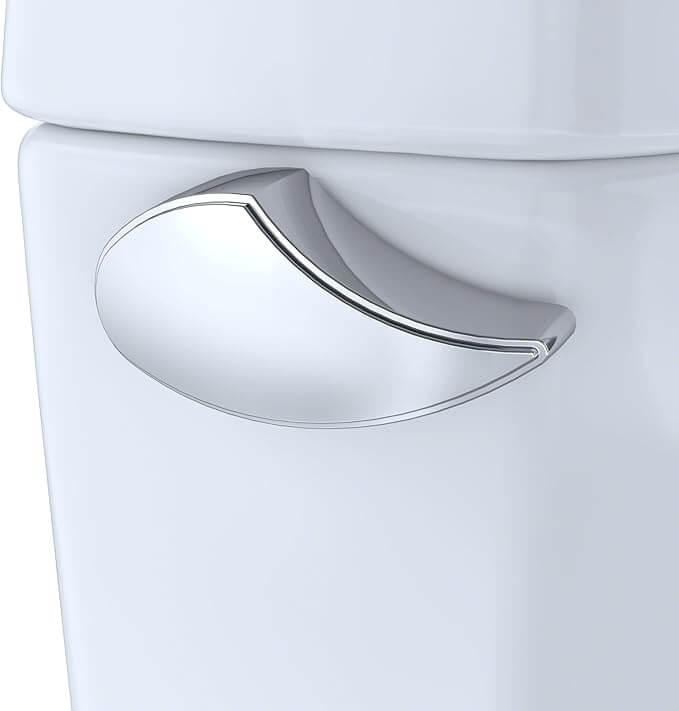 Close-up of a white toilet with a silver handle on a light gray background