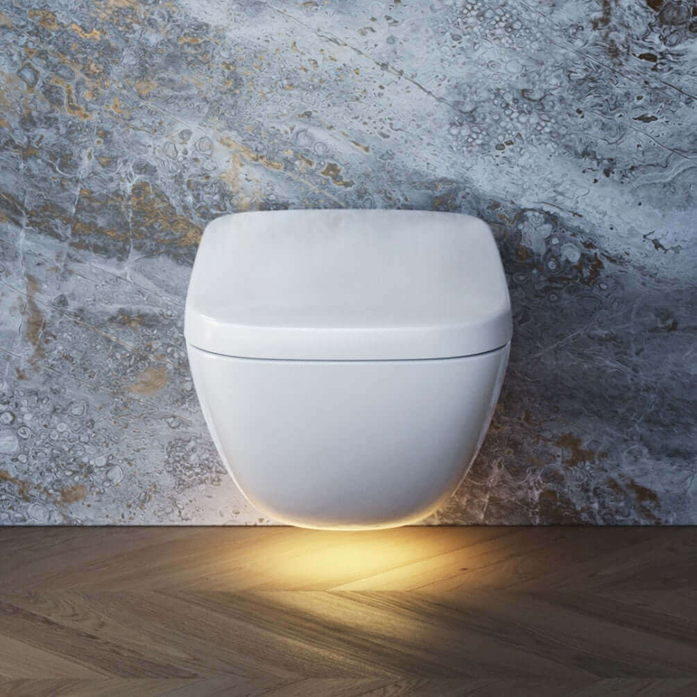 Wall mounted toilet with nightlight shining on floor underneath