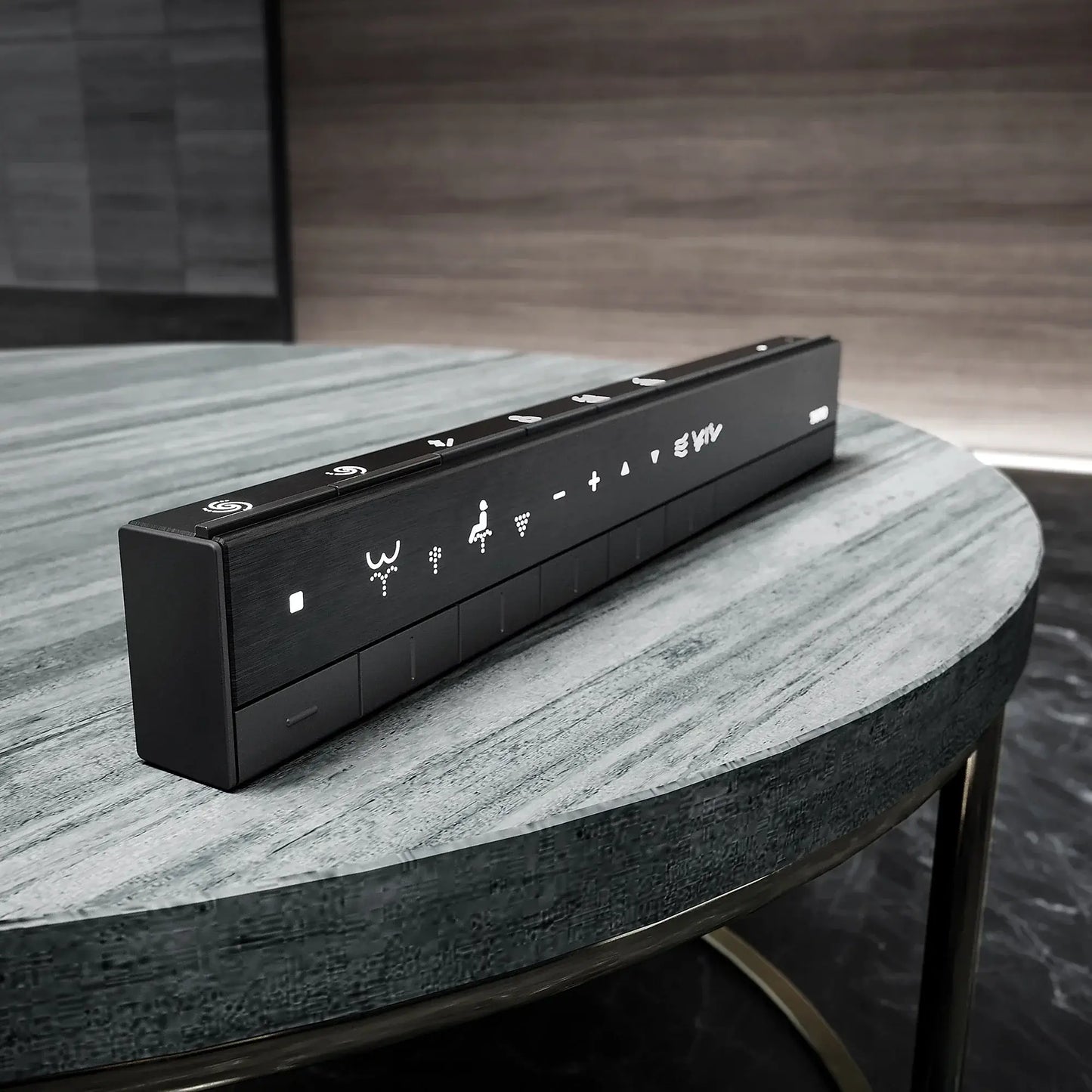 Black remote control on a marble table