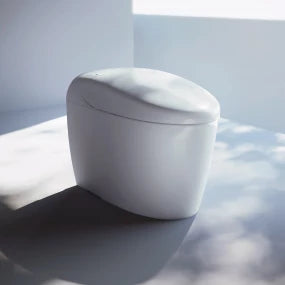 White toilet bowl with closed lid on a light gray floor