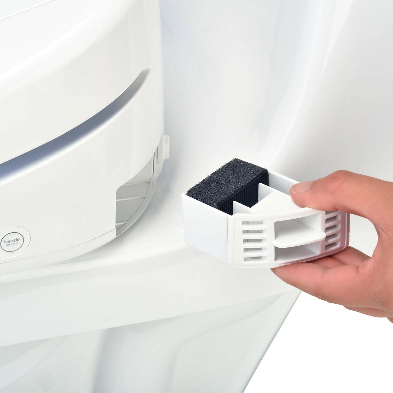 User holding a carbon deodorizer cartridge for the Brondell Swash 1400 Luxury Smart Bidet Toilet Seat.