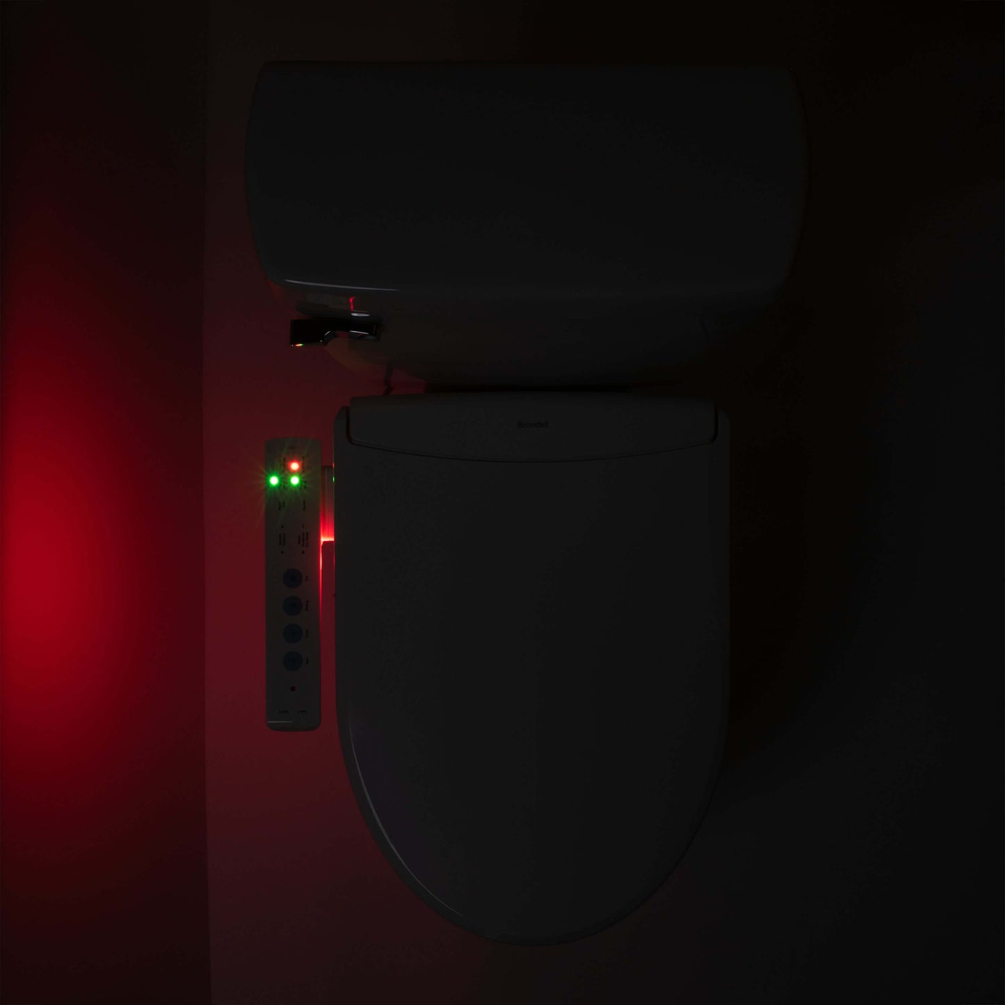 Brondell Swash Thinline T22 Smart Bidet Seat with side arm control and LED nightlight in a dark bathroom.