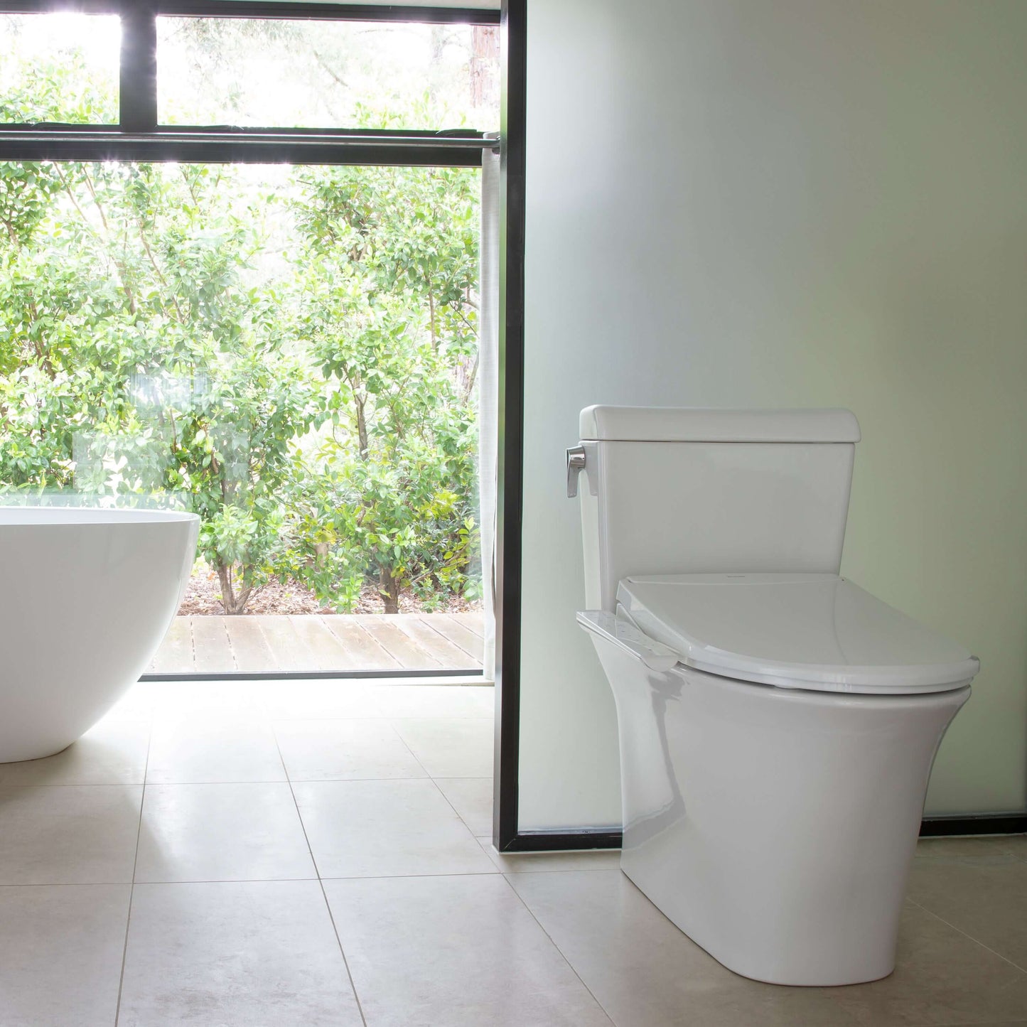 Modern bathroom featuring the Brondell Swash Thinline T22 Smart Bidet Toilet Seat and a freestanding bathtub.