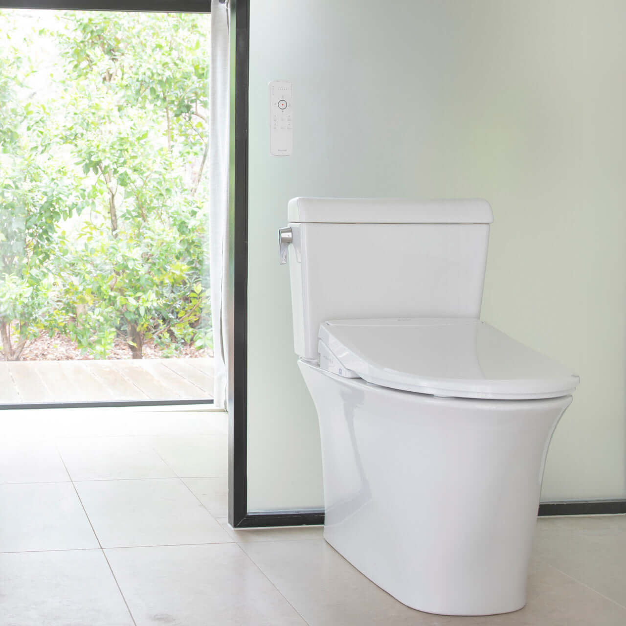 Brondell Swash Thinline T44 smart bidet seat installed on a modern toilet in a bright, airy bathroom.