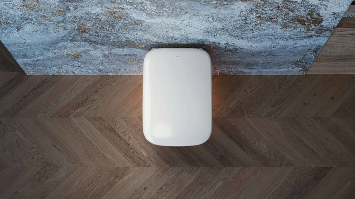 Wall mounted toilet with nightlight shining on floor underneath looking down from above