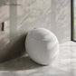 Swiss Madison Plaisir Round Smart Bidet Toilet in modern bathroom setting with remote control.
