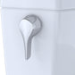 Close-up of a white toilet with a silver handle on a white background