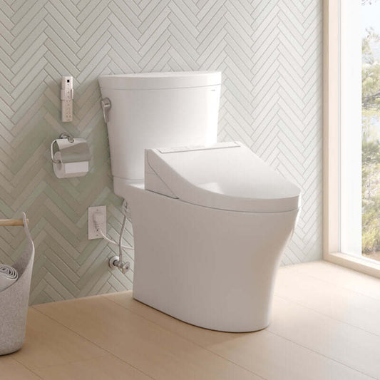 Modern toilet in a bathroom with a chevron-patterned wall and window.