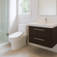 Modern bathroom with toilet, sink, and mirror