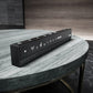 Black remote control on a marble table