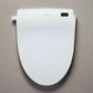 Blooming R1570 Bidet seat on beige surface, looking from above, lid closed