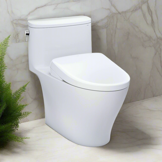 White toilet in a bathroom with marble walls and a plant.